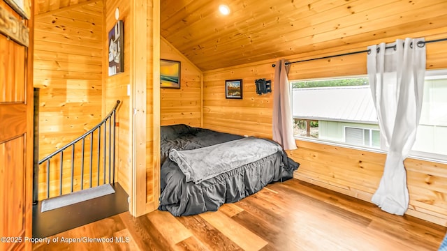329 River Frontage Rd # 14, Silt, CO 81652 - bedroom featuring vaulted ceiling, wood finished floors, wood walls, and wooden ceiling