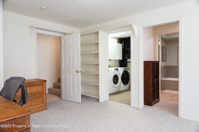 carpeted office space featuring washing machine and dryer