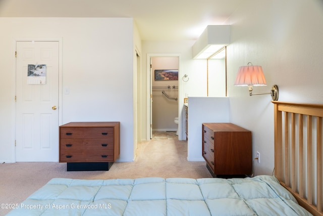 bedroom featuring light carpet, a walk in closet, and a closet