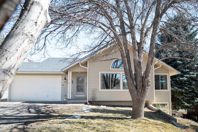 view of front of property featuring driveway and an attached garage