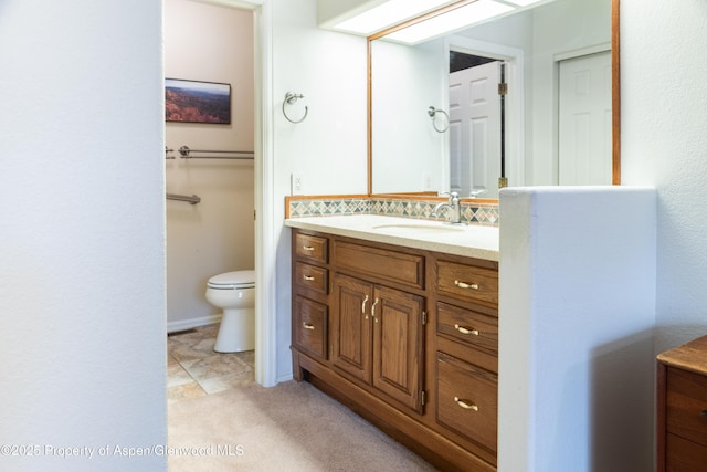 bathroom with toilet and vanity