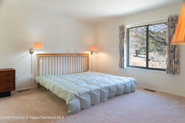 bedroom featuring carpet floors, baseboards, and visible vents