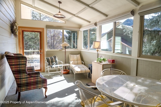 sunroom with lofted ceiling with beams