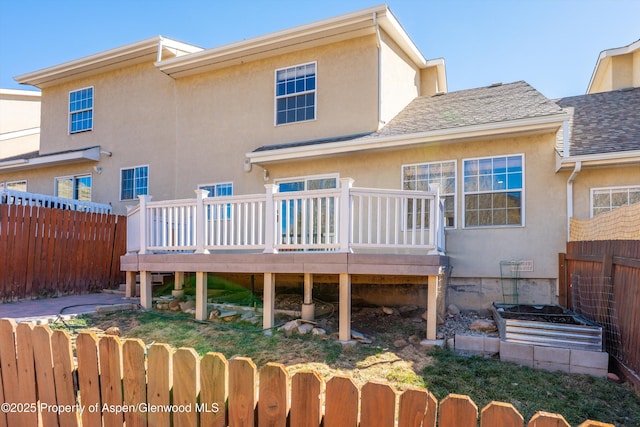 721 Pine Ct, New Castle, CO 81647 - rear view of house featuring a fenced backyard, stucco siding, and a deck