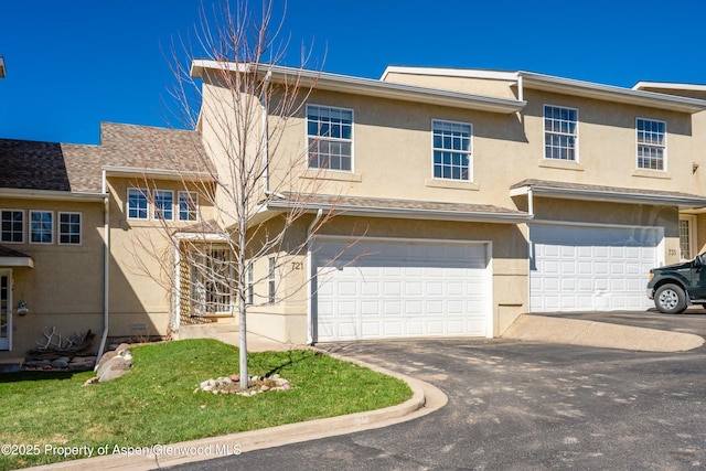 721 Pine Ct, New Castle, CO 81647 - view of property with a garage, driveway, and stucco siding