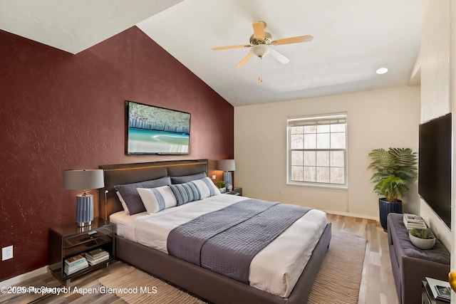 721 Pine Ct, New Castle, CO 81647 - bedroom featuring baseboards, wood finished floors, a ceiling fan, lofted ceiling, and an accent wall
