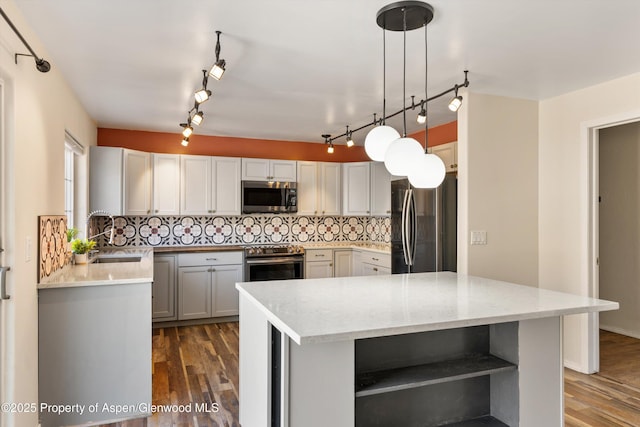 721 Pine Ct, New Castle, CO 81647 - kitchen featuring tasteful backsplash, open shelves, dark wood finished floors, a sink, and appliances with stainless steel finishes