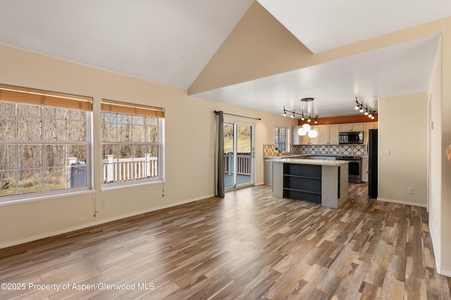 721 Pine Ct, New Castle, CO 81647 - kitchen with light countertops, a center island, stainless steel electric range oven, freestanding refrigerator, and a notable chandelier