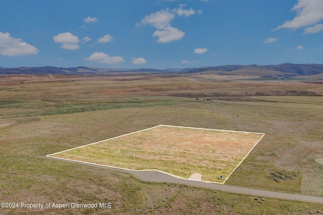 drone / aerial view featuring a rural view and a mountain view