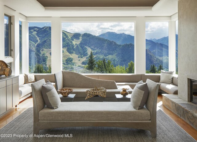 sunroom / solarium with a mountain view and a fireplace