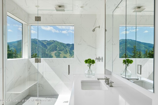 bathroom featuring a mountain view, sink, and a shower with shower door