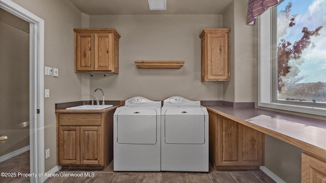 washroom featuring sink, washer and clothes dryer, tile patterned floors, and cabinets