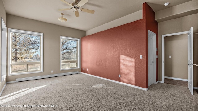 empty room featuring a baseboard radiator, carpet flooring, and ceiling fan