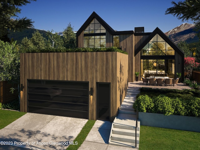 contemporary house with a mountain view and a patio