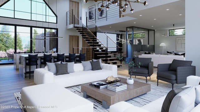 living room featuring a towering ceiling, hardwood / wood-style floors, and a notable chandelier