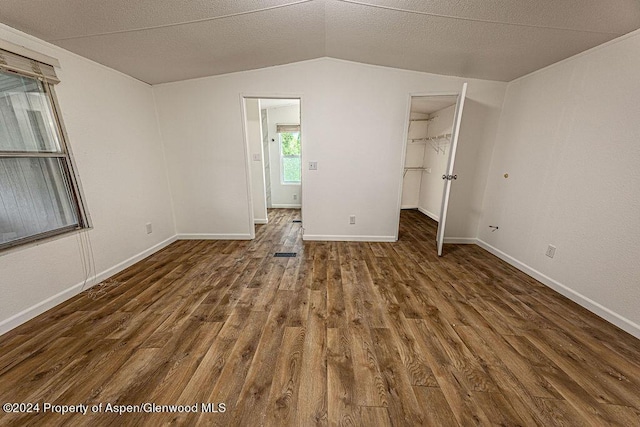 261 Ellis Ave, Maybell, CO 81640 - unfurnished bedroom with baseboards, a spacious closet, wood finished floors, and vaulted ceiling