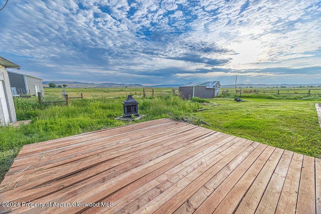 261 Ellis Ave, Maybell, CO 81640 - wooden terrace with a mountain view, fence, a shed, and an outbuilding