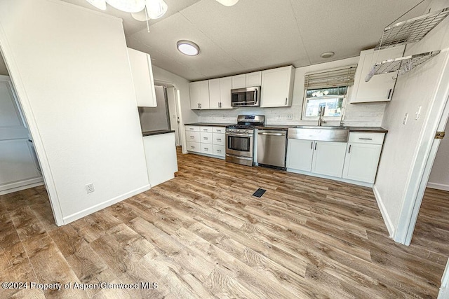 261 Ellis Ave, Maybell, CO 81640 - kitchen featuring wood finished floors, stainless steel appliances, and a sink