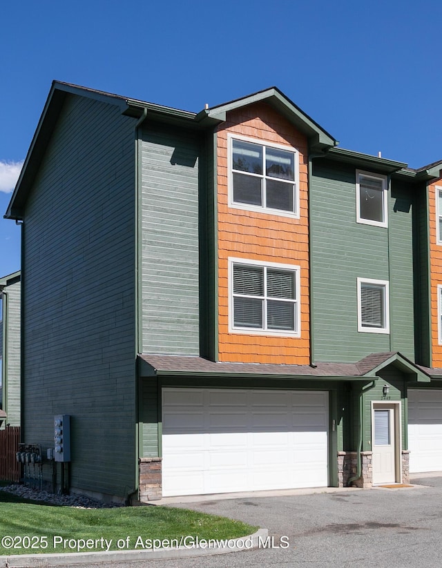 2449 Pine Ln, Rifle, CO 81650 - view of front facade with an attached garage and asphalt driveway