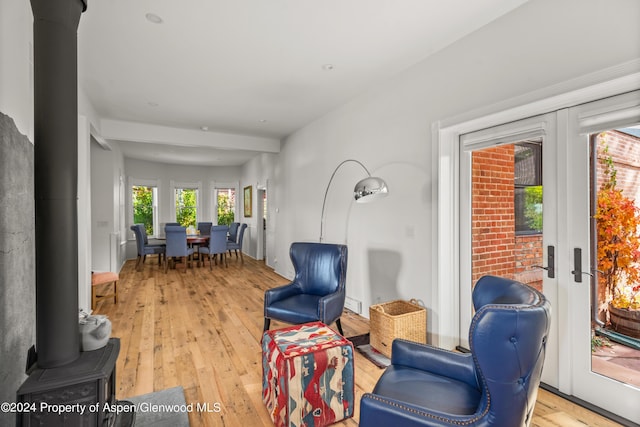 living area with french doors and light hardwood / wood-style flooring