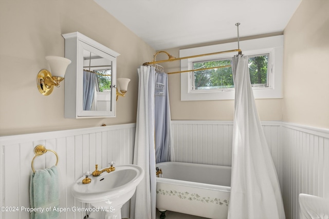 bathroom with shower / bath combination with curtain and sink