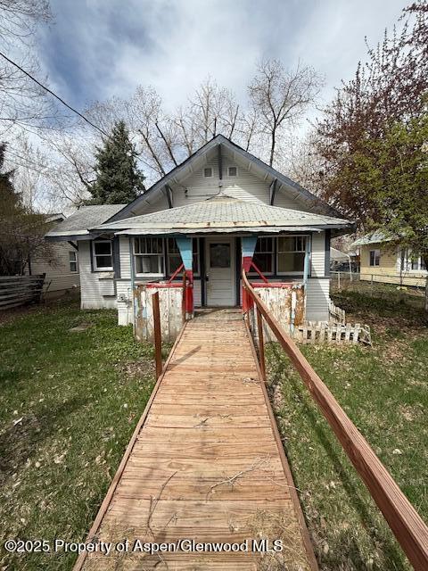 545 Taylor St, Craig, CO 81625 - bathroom featuring tile patterned floors, wood walls, baseboards, and a sink