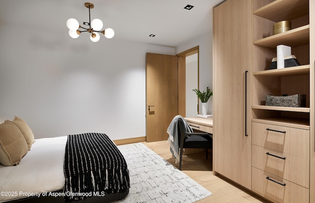 bedroom featuring light wood-style floors, baseboards, and a chandelier