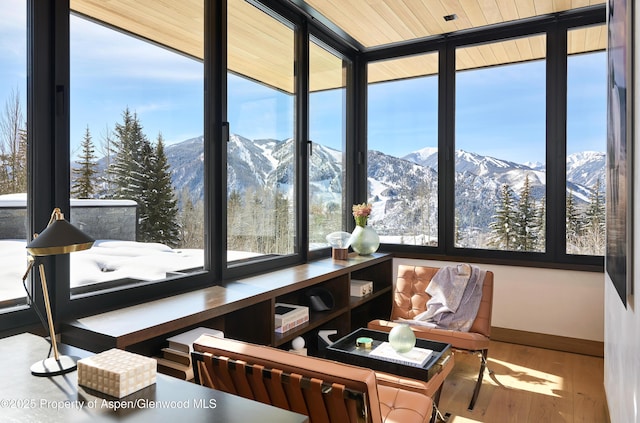 sunroom / solarium featuring a mountain view