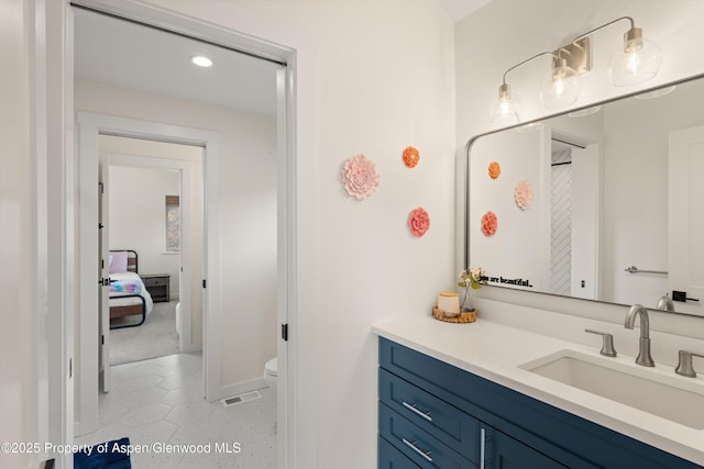 bathroom featuring visible vents, toilet, and vanity