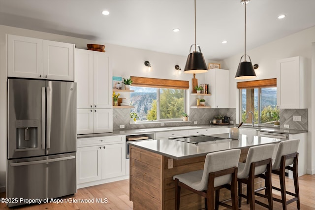 kitchen with white cabinetry, open shelves, black electric cooktop, and stainless steel refrigerator with ice dispenser