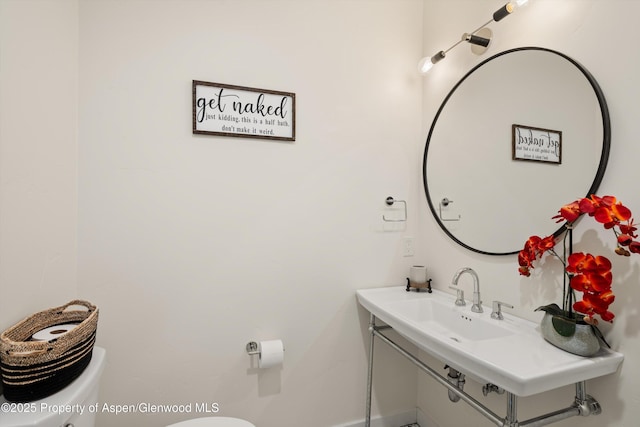 half bathroom with toilet and vanity