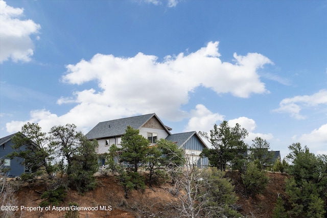 view of home's exterior featuring board and batten siding and a shingled roof