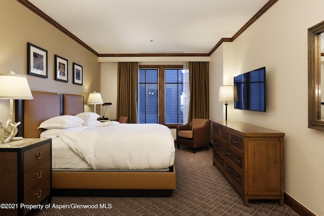 bedroom with crown molding and dark colored carpet