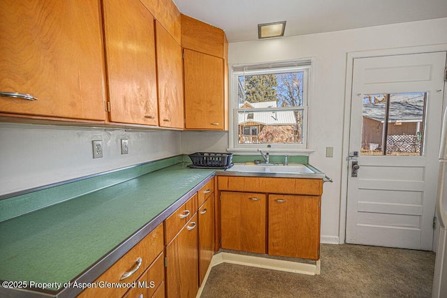 kitchen featuring brown cabinets and a sink