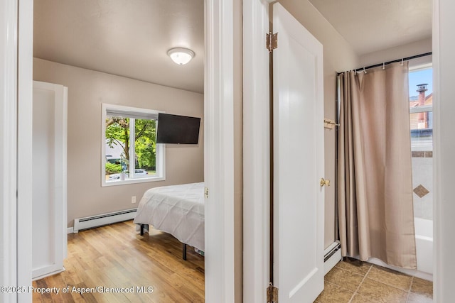 1114 Blake Ave, Glenwood Springs, CO 81601 - bedroom with a baseboard heating unit and light wood finished floors