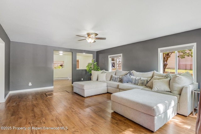 1114 Blake Ave, Glenwood Springs, CO 81601 - living area featuring a baseboard heating unit, ceiling fan, plenty of natural light, and wood finished floors