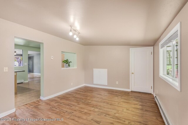 1114 Blake Ave, Glenwood Springs, CO 81601 - empty room with baseboard heating, healthy amount of natural light, and light wood-type flooring