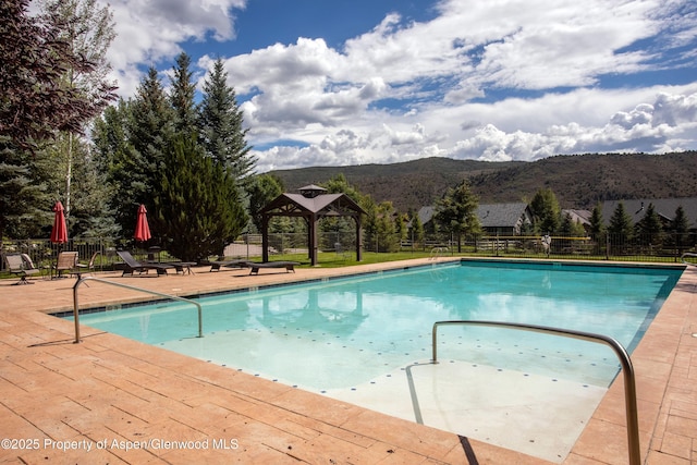 123 Corral Dr, Carbondale, CO 81623 - community pool featuring a mountain view, fence, a patio area, and a gazebo
