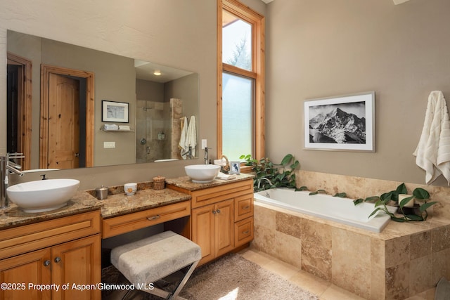 123 Corral Dr, Carbondale, CO 81623 - bathroom featuring a tile shower, a garden tub, a sink, and double vanity