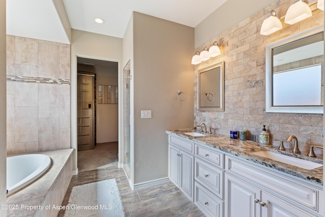 1326 Fairway Dr, Fruita, CO 81521 - full bath with double vanity, a sink, a bath, and baseboards