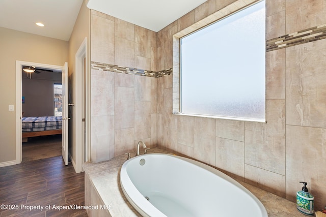 1326 Fairway Dr, Fruita, CO 81521 - ensuite bathroom featuring a garden tub, ensuite bath, and wood finished floors