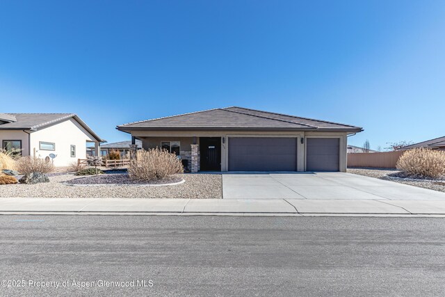 1326 Fairway Dr, Fruita, CO 81521 - view of front of house with concrete driveway, an attached garage, and a tile roof