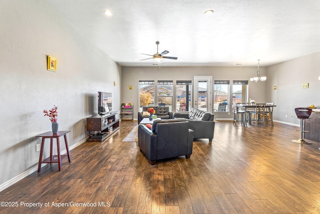 1326 Fairway Dr, Fruita, CO 81521 - living area with ceiling fan with notable chandelier, hardwood / wood-style floors, and baseboards