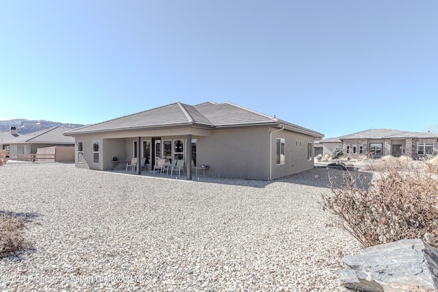 1326 Fairway Dr, Fruita, CO 81521 - back of house featuring a tile roof, a patio area, and stucco siding