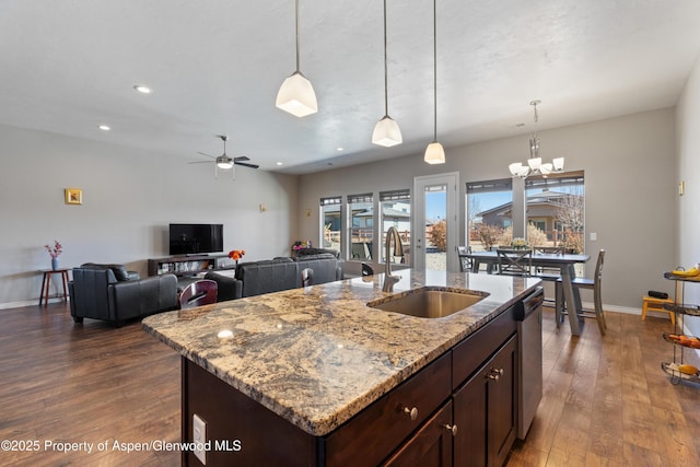 1326 Fairway Dr, Fruita, CO 81521 - kitchen featuring dark wood-style flooring, a sink, stainless steel dishwasher, light stone countertops, and decorative light fixtures