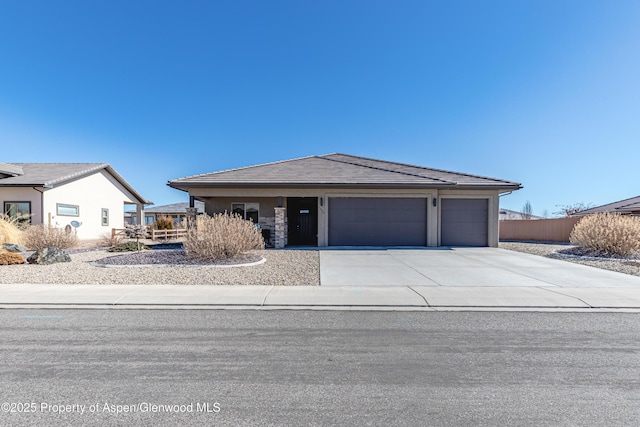 1326 Fairway Dr, Fruita, CO 81521 - view of front of home featuring concrete driveway, an attached garage, and a tiled roof