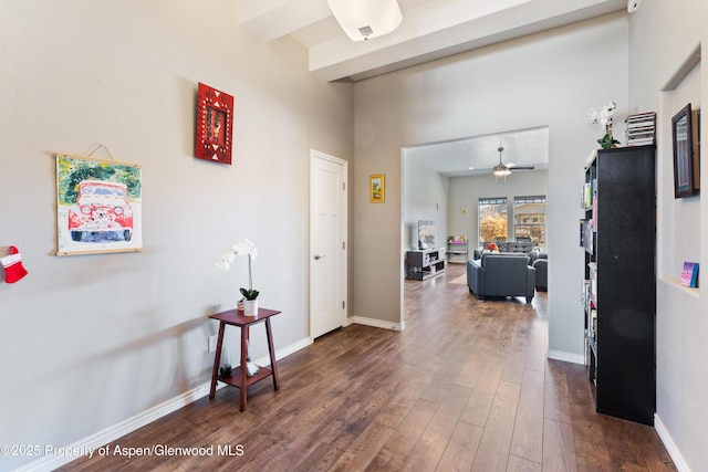 1326 Fairway Dr, Fruita, CO 81521 - hall featuring dark wood finished floors, beamed ceiling, and baseboards