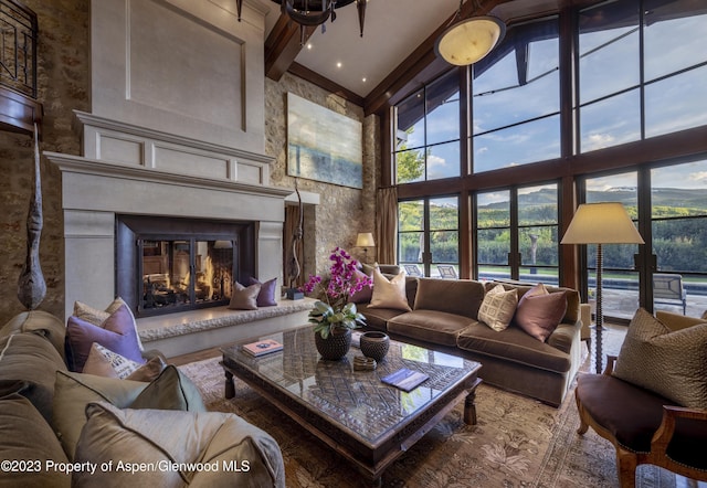 living room with beamed ceiling and a high ceiling