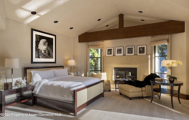 carpeted bedroom featuring vaulted ceiling and multiple windows