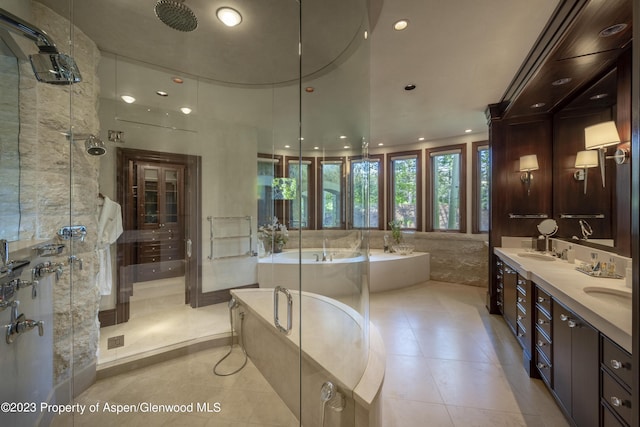 bathroom with tile patterned flooring, vanity, and independent shower and bath